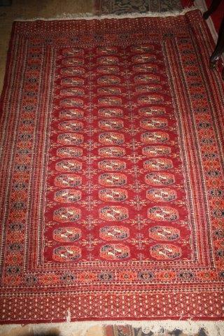 Bokhara red ground rug, woven with three rows of elephants foot(-)
